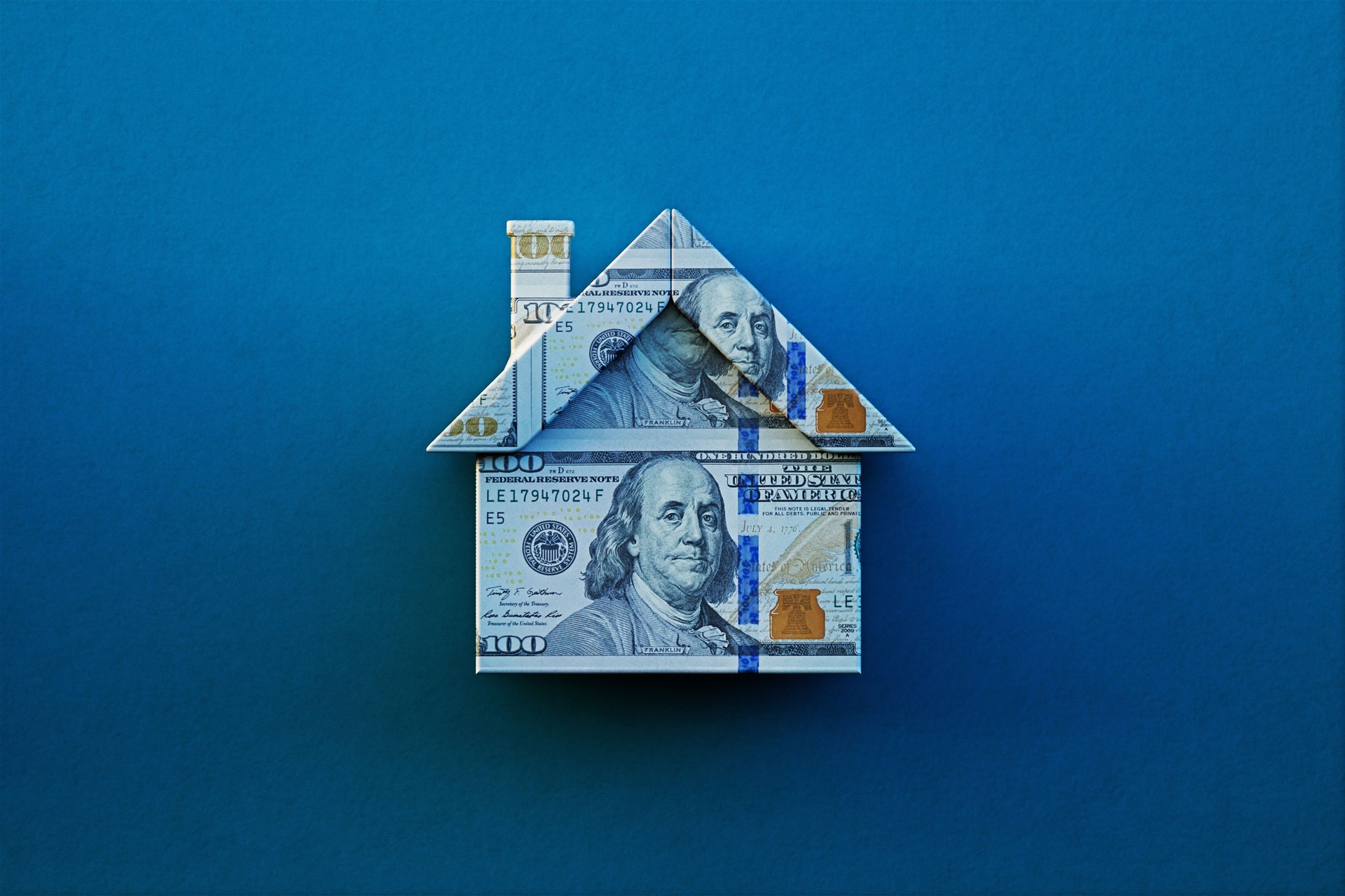 House Object Textured With 100 American Dollar Bill On Blue Background